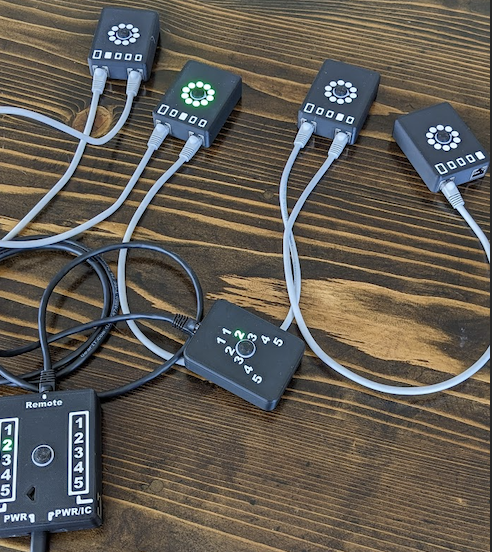 eeocengineering.cc set — black control boxes with numbered dials and LED-ring buzzers